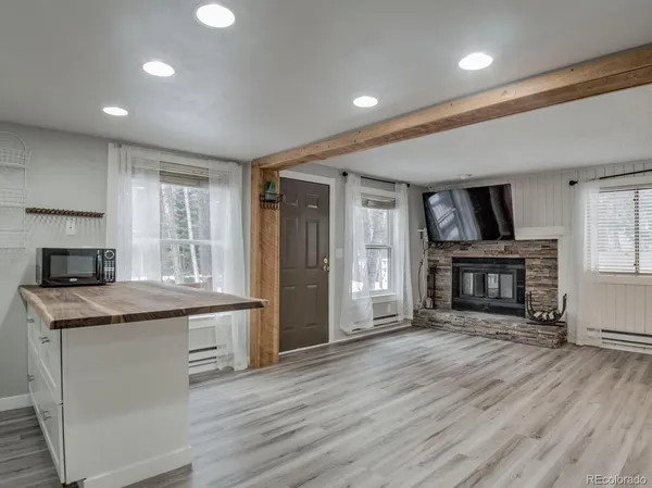 a kitchen with kitchen island a sink stainless steel appliances and cabinets