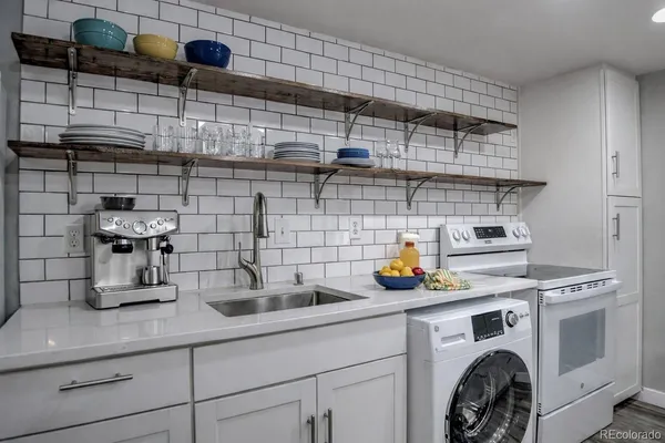 a kitchen with kitchen island a white cabinets and wooden floor