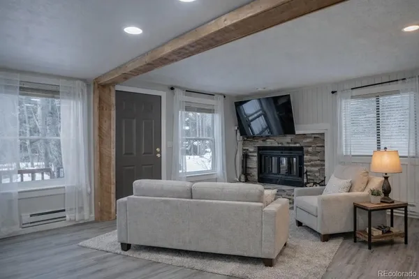 a open kitchen with kitchen island a sink dishwasher a dining table and chairs with wooden floor