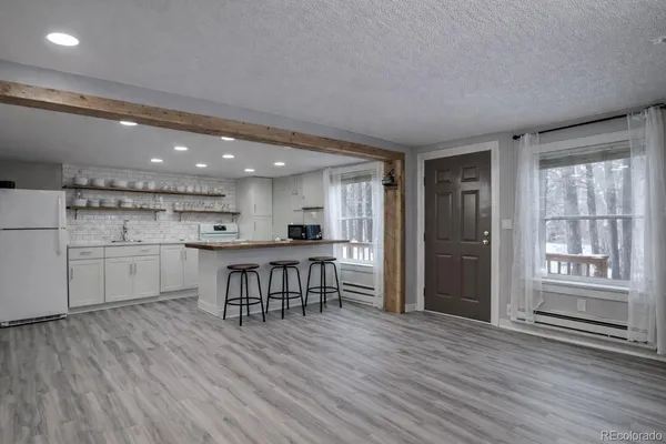a view of a kitchen with a sink and wooden floor