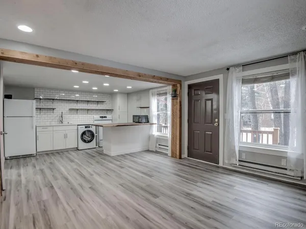 a kitchen with a stove and a refrigerator