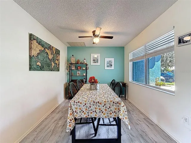 a kitchen with granite countertop a refrigerator and a stove top oven
