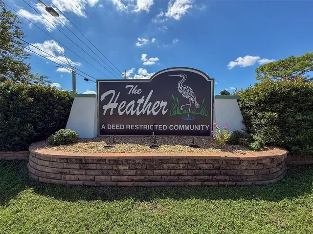 a wooden bench sitting in front of a building