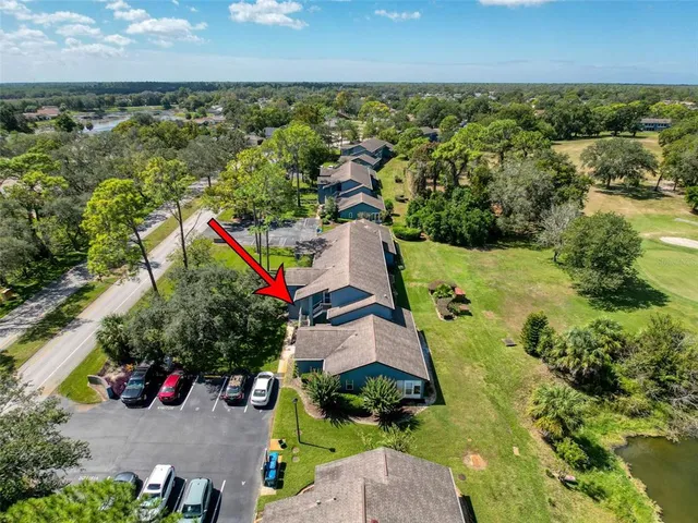 an aerial view of residential houses with outdoor space and swimming pool