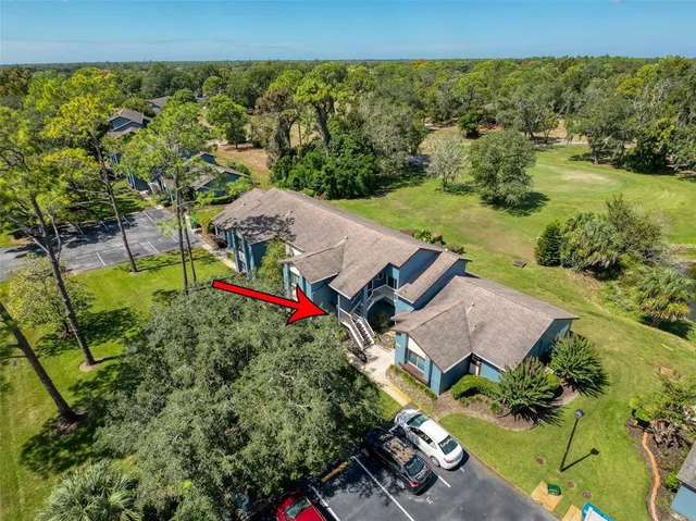 an aerial view of a house with big yard