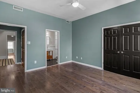 wooden floor chandelier and window in a room