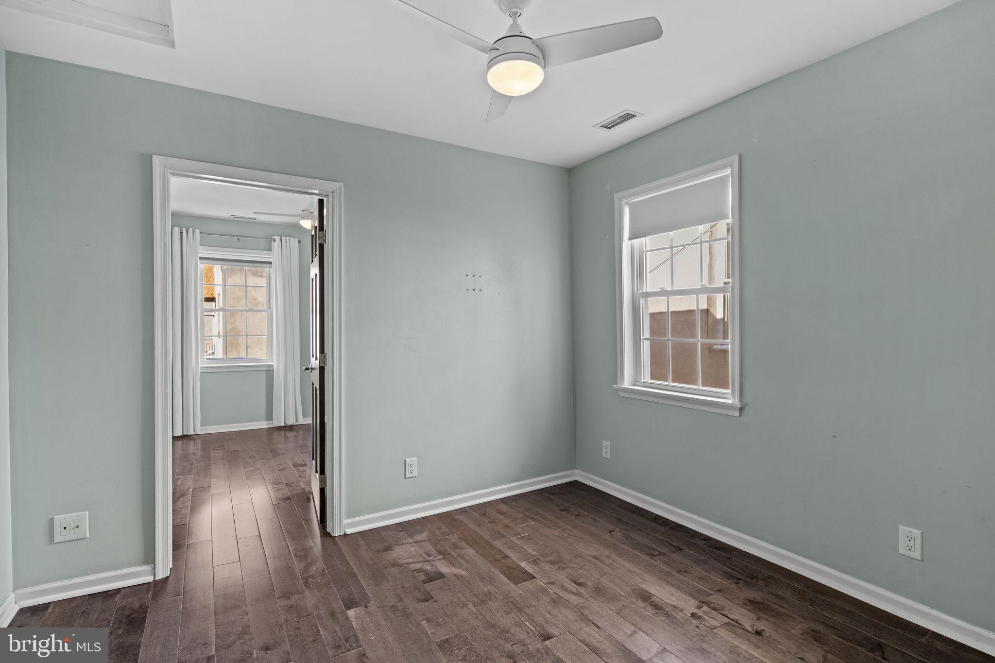 828 South 5th Street Philadelphia, PA 19147 - Photo 17 of 27 an empty room with wooden floor closet and windows