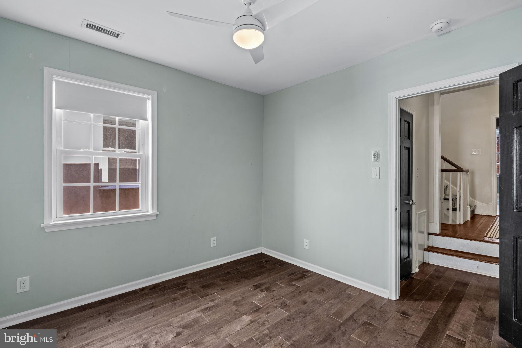 828 South 5th Street Philadelphia, PA 19147 - Photo 18 of 27 an empty room with wooden floor and windows