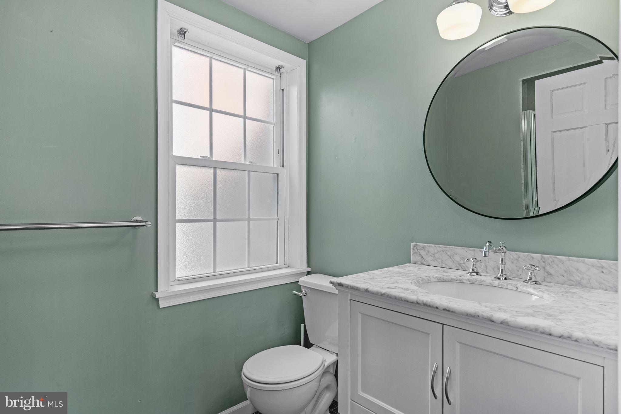 828 South 5th Street Philadelphia, PA 19147 - Photo 24 of 27 a bathroom with a granite countertop toilet sink and mirror