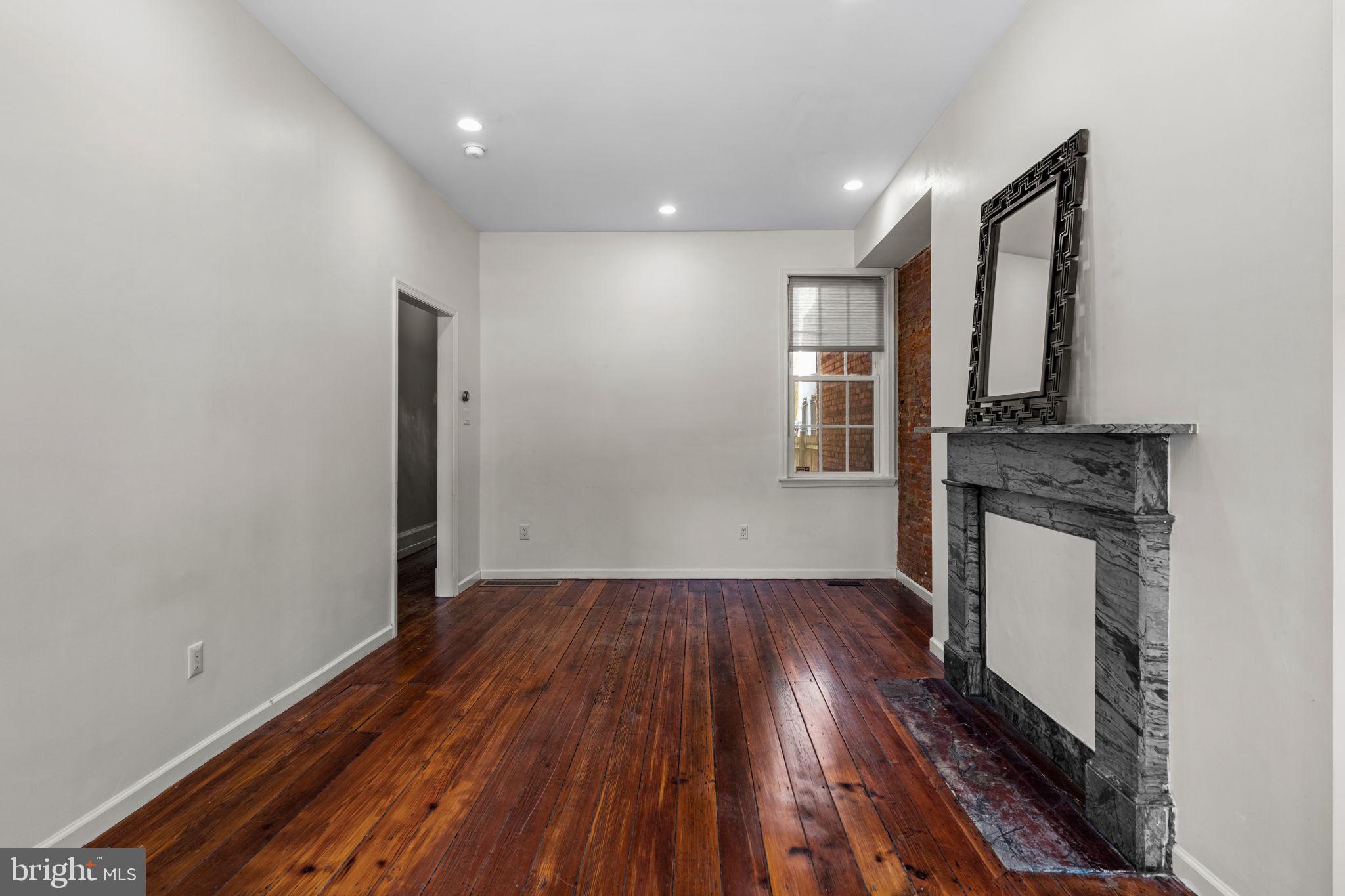 828 South 5th Street Philadelphia, PA 19147 - Photo 5 of 27 a view of a hallway with wooden floor and a fireplace
