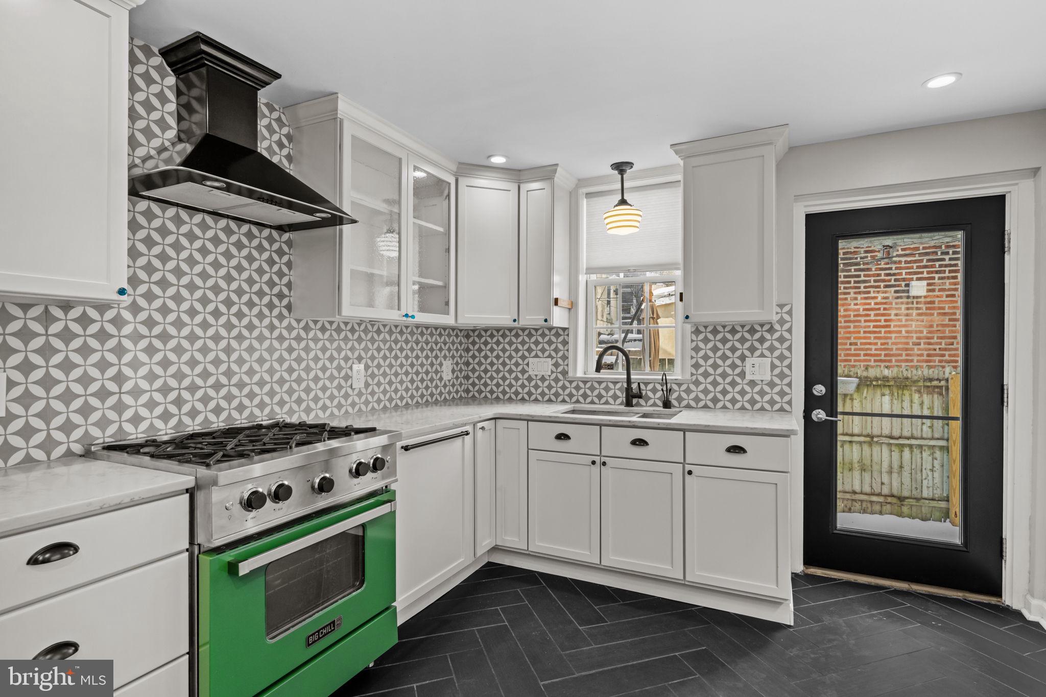 828 South 5th Street Philadelphia, PA 19147 - Photo 9 of 27 a kitchen with granite countertop a stove sink and cabinets