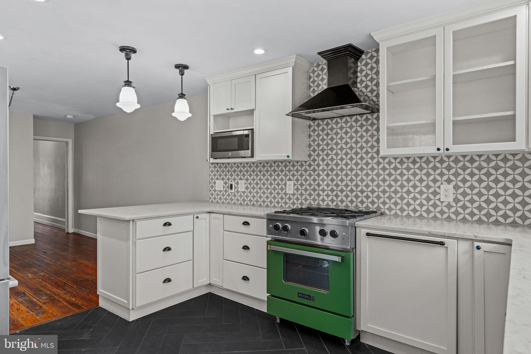 828 South 5th Street Philadelphia, PA 19147 - Photo 10 of 27 a kitchen with a stove cabinets and wooden floor