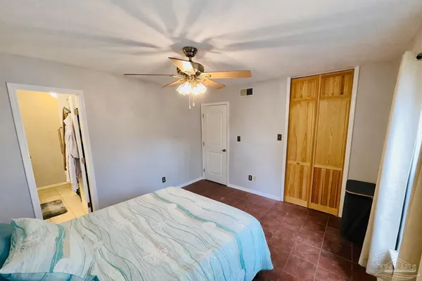 a bedroom with a bed and a mirror