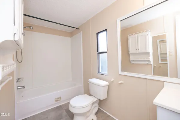 a white toilet sitting next to a bath tub shower