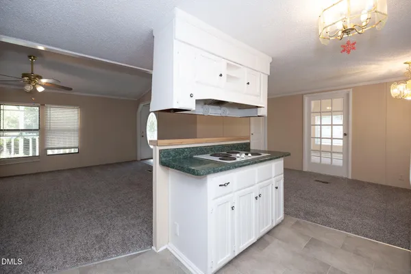 a kitchen with granite countertop a stove and a sink