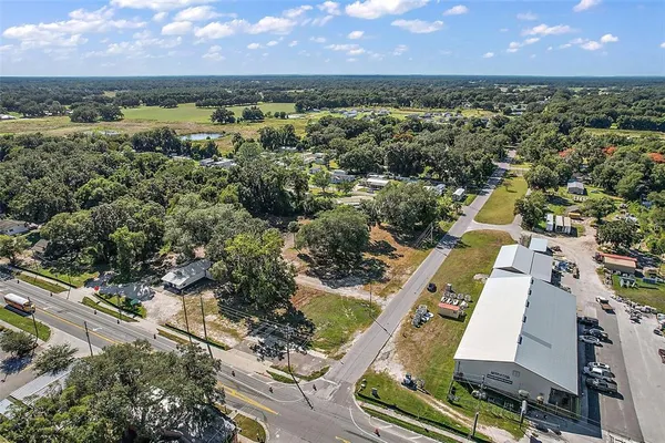 an aerial view of residential houses with outdoor space and ocean view