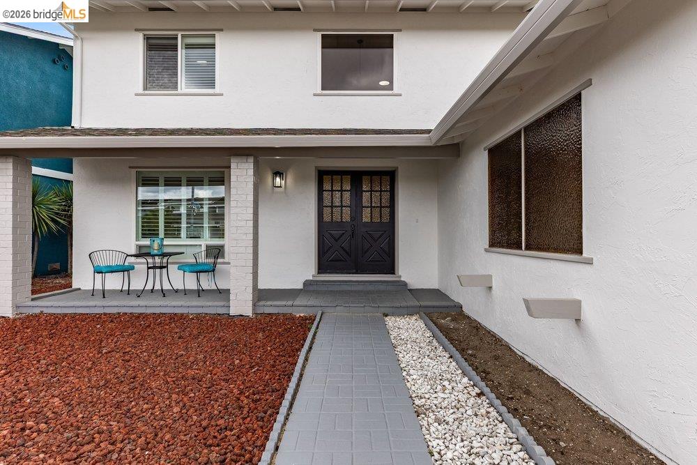 1298 Ribbon Street Foster City, CA 94404 - Photo 11 of 86 White stucco exterior with a covered porch featuring brick columns