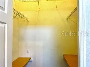a view of a room with wooden floor and fan