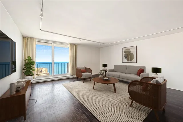 a living room with furniture and a window with balcony view