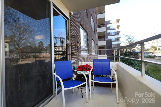 a two chairs sitting in a balcony