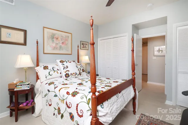 a bedroom with bed and cupboard