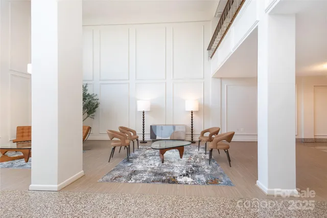a living room with furniture a rug and a window