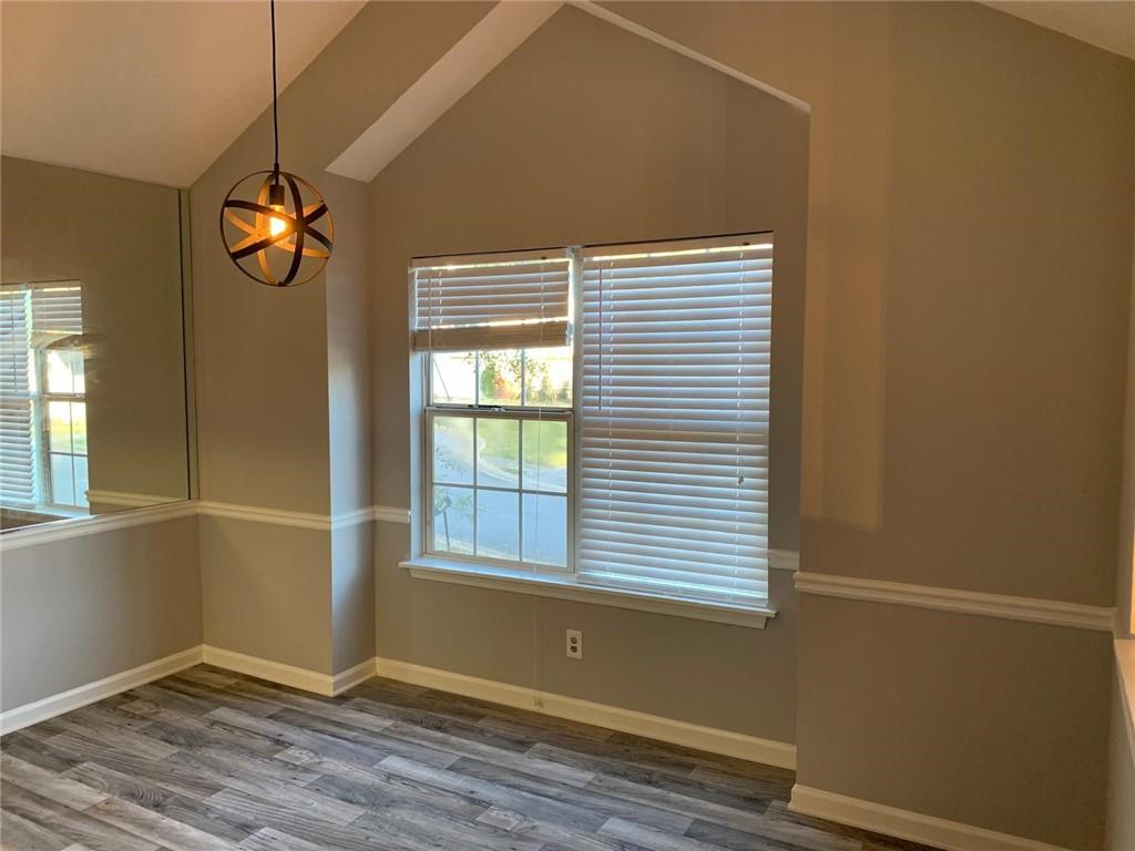 4055 Mistymorn Lane Powder Springs, GA 30127 - Photo 3 of 8 a view of an empty room with wooden floor and a window