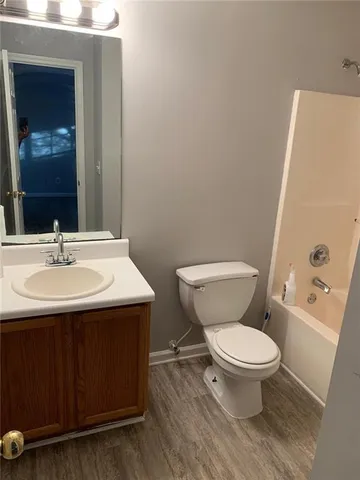 a bathroom with a sink toilet and a mirror