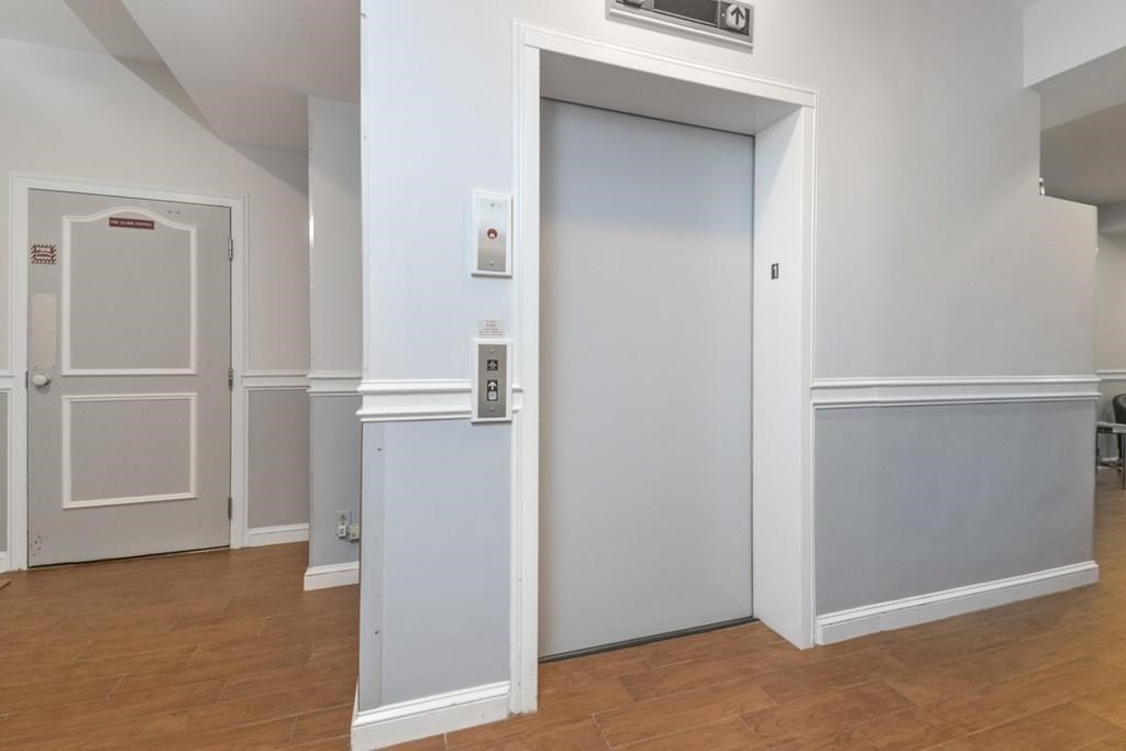 19 Wiget Street, Unit 302 Boston, MA 02113 - Photo 12 of 15 a view of empty room with wooden floor