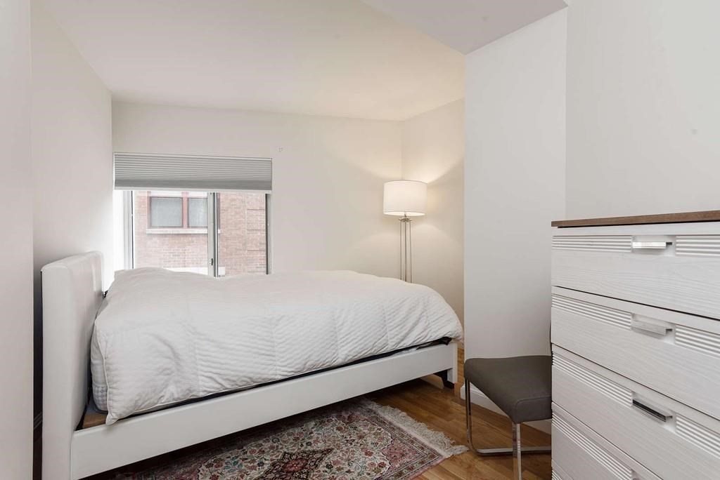 19 Wiget Street, Unit 302 Boston, MA 02113 - Photo 8 of 15 a bedroom with a bed and a lamp on table