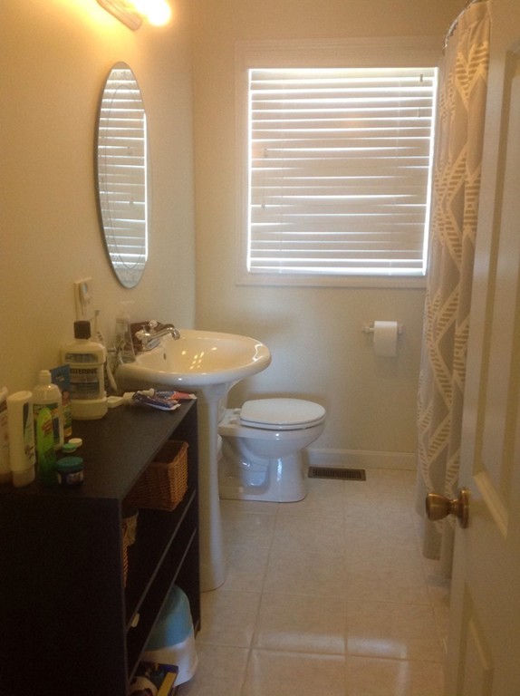 7 Farquhar Road Sturbridge, MA 01566 - Photo 12 of 18 a bathroom with a granite countertop toilet a sink and a mirror