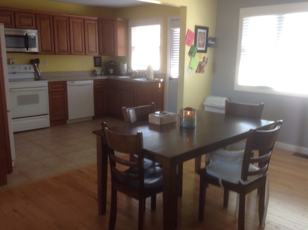 7 Farquhar Road Sturbridge, MA 01566 - Photo 7 of 18 a kitchen with a table chairs sink and cabinets