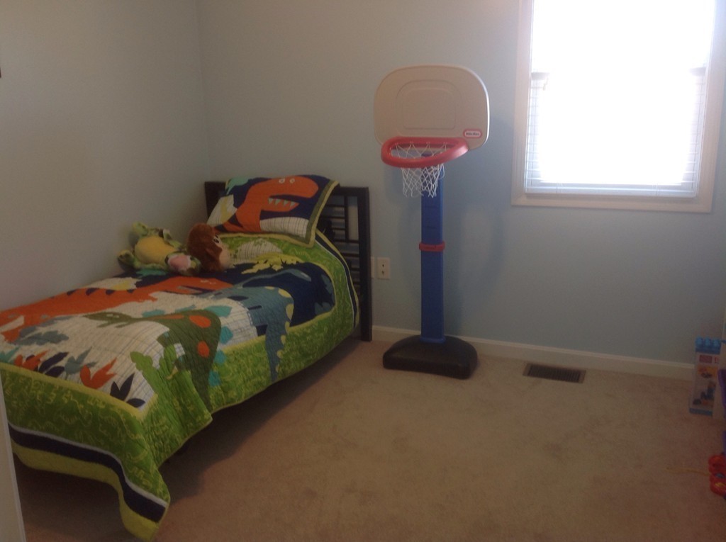 7 Farquhar Road Sturbridge, MA 01566 - Photo 8 of 18 a bedroom with a bed and a chandelier