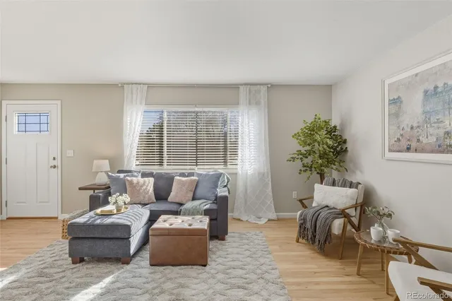 a living room with furniture and a potted plant
