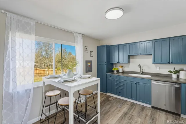 a kitchen with granite countertop wooden cabinets and white appliances