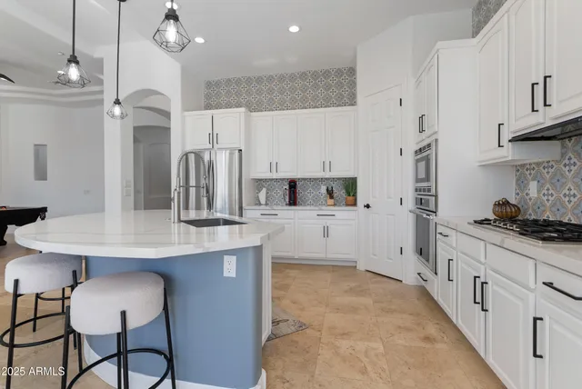 a dining room with furniture and a chandelier