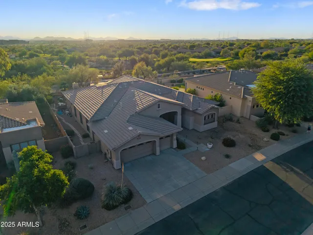 a living room with patio furniture and a chandelier