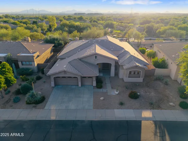 a view of a patio with table and chairs under an umbrella
