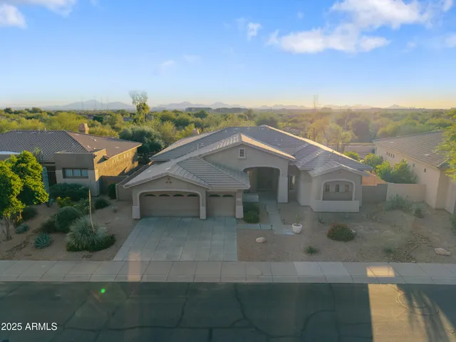 a view of a patio with couches table and chairs and potted plants