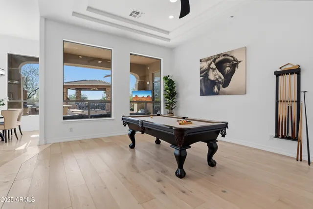 a room with table chairs and wooden floor