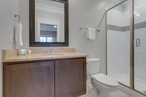 a bathroom with a sink toilet and mirror