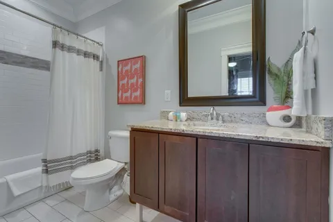 a bathroom with a granite countertop sink toilet a large mirror and shower