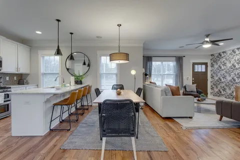 a living room with furniture a window and chairs