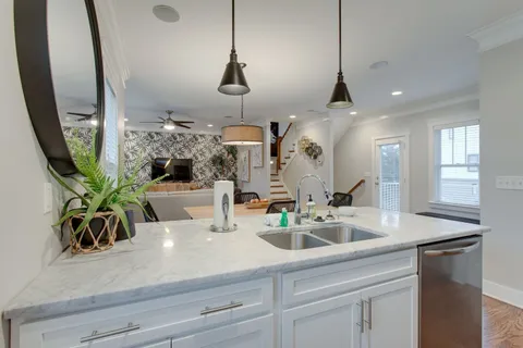 a kitchen with sink a counter and cabinets