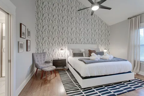 a bedroom with a bed and a chandelier