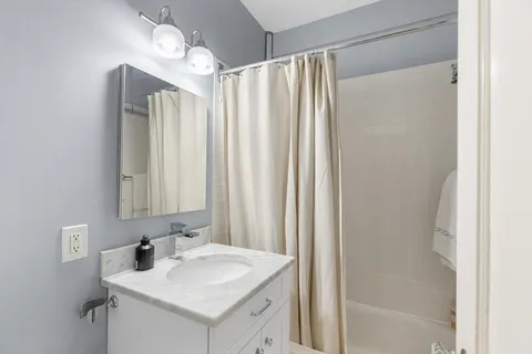 a bathroom with a sink vanity and a mirror