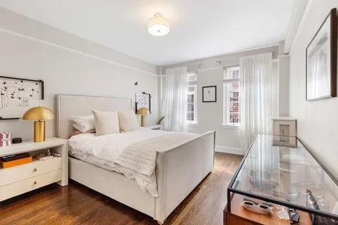 a spacious bedroom with a bed and window
