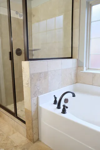 a bathroom with a bathtub and shower