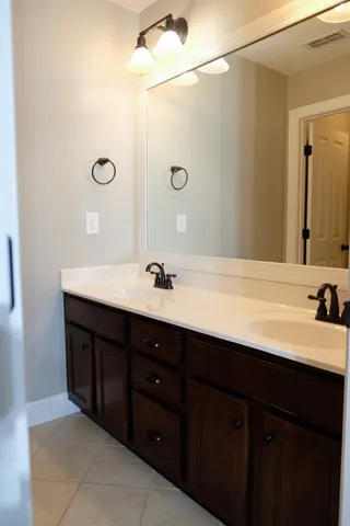 a bathroom with a double vanity sink and mirror