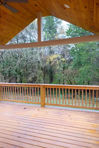 a view of balcony with wooden floor and fence
